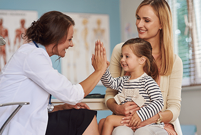 female doctor with mom and daughter